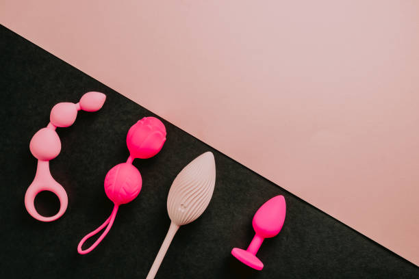 Sex toys and accessories on pink background. Flat lay